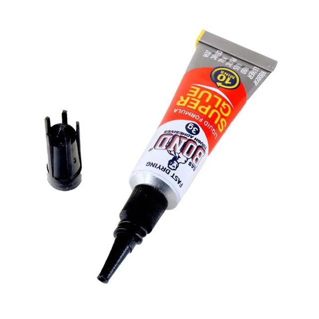 Super glue tube with applicator on a white background