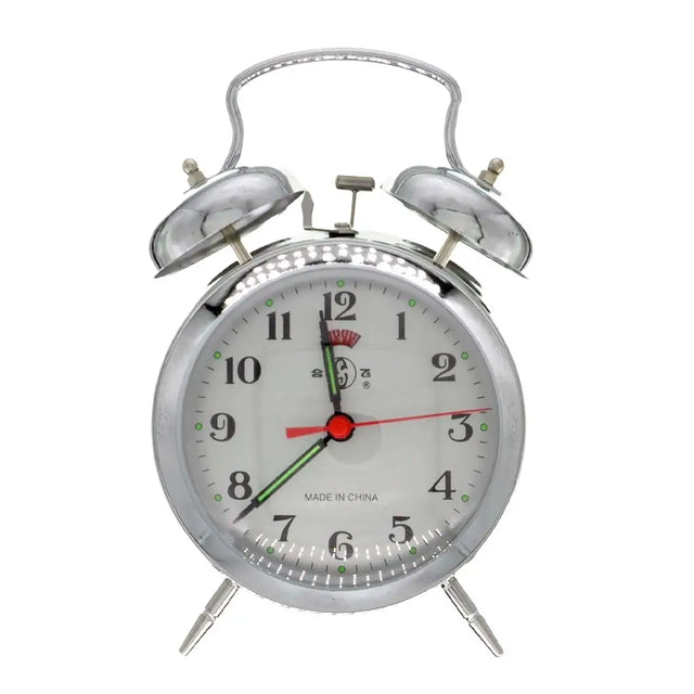 Silver alarm clock with white face on a white background