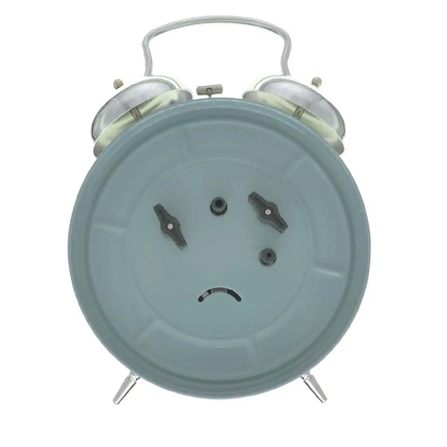 Alarm clock with a sad face on a white background