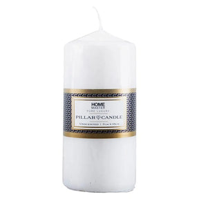 White pillar candle with a label on a white background