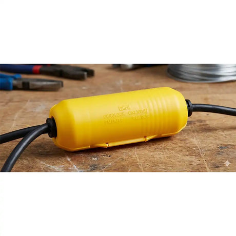 Yellow cable protector with black cable on a wooden surface