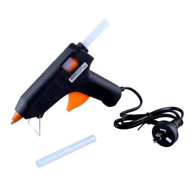 Black and orange glue gun with a white cord on a white background