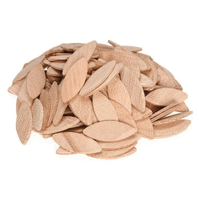 Pile of light brown pumpkin seeds on a white background