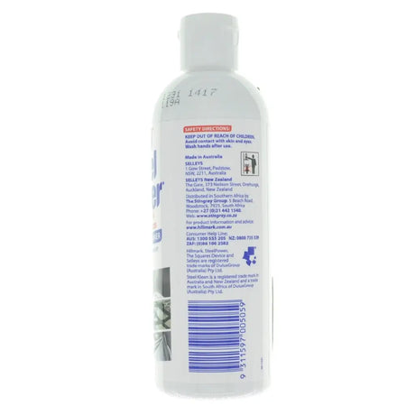 Back view of a white bottle with text and a barcode on a white background