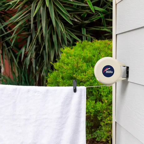 Hills product on a clothesline with greenery in the background