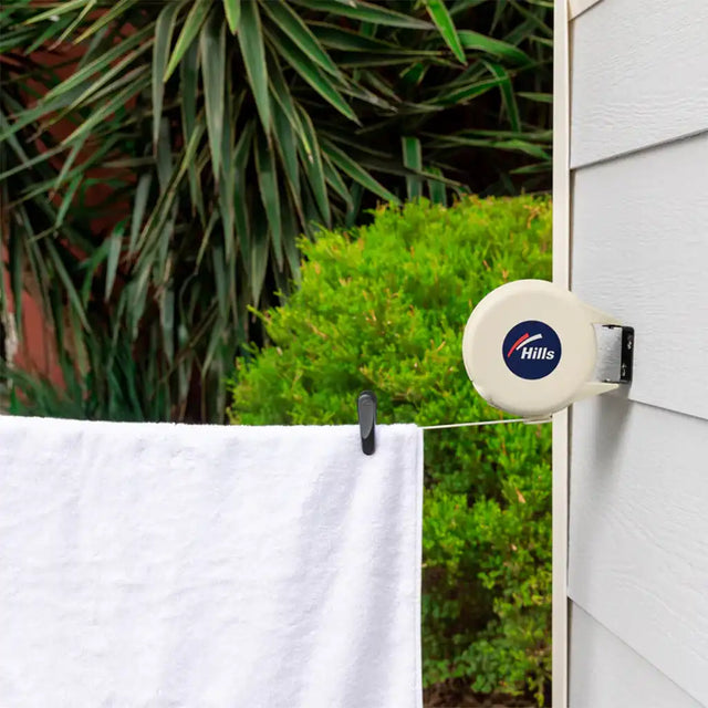 Hills product on a clothesline with greenery in the background