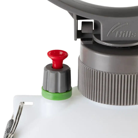 Close-up of a compress spray bottle with a red and green valve on a white background