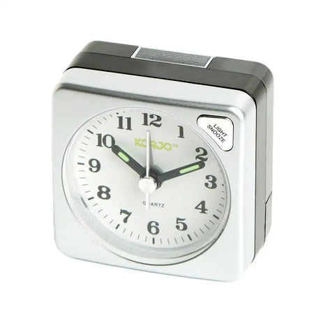 Silver alarm clock with white face on a white background