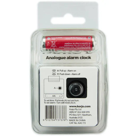 Analogue alarm clock in packaging with battery on a white background