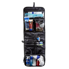 Black travel toiletry bag with various items on a white background