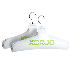 Two white hangers with 'KORU' branding on a white background