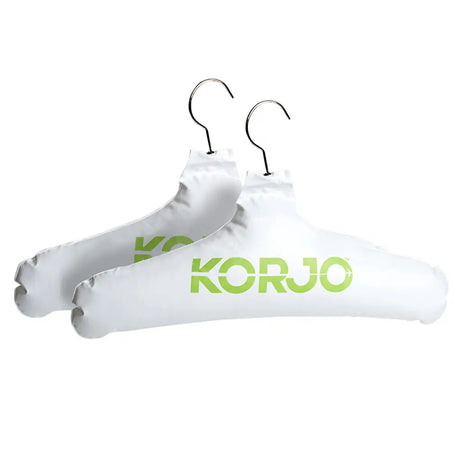 Two white hangers with 'KORU' branding on a white background
