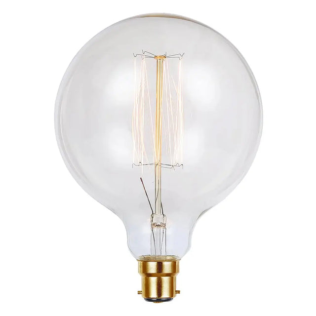 Clear light bulb with gold base on a white background