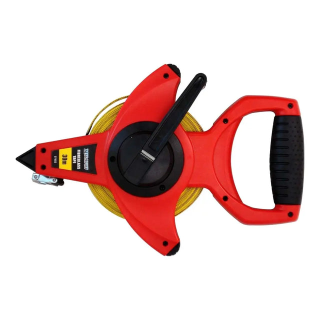 Red tape measure with black handle on a white background