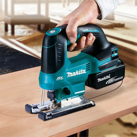 Makita cordless jigsaw being used on a wooden surface
