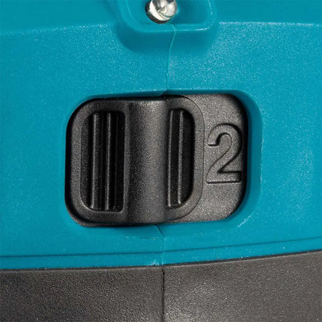 Close-up of a teal and black plastic switch or dial with the number 2 embossed on the side.