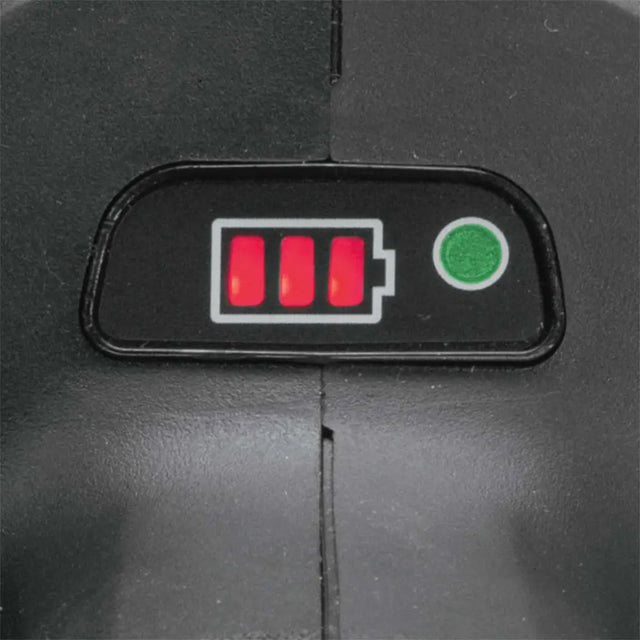 A close-up of a black plastic control panel featuring a red battery icon with three illuminated red lights and a green circular button.
