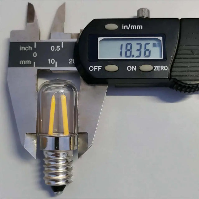 LED light bulb being measured with a digital caliper on a white background