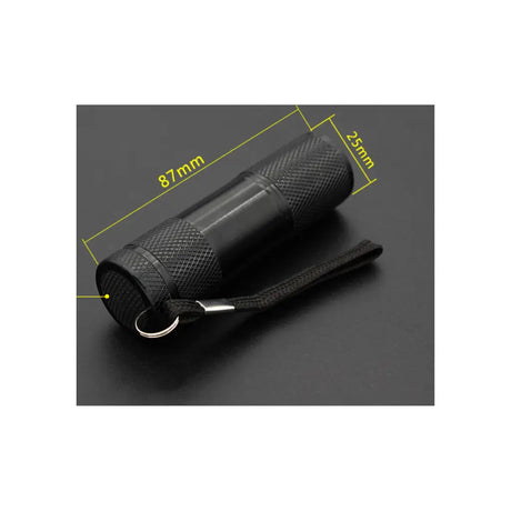 Black flashlight with measurement details on a dark background