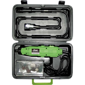A green handheld rotary tool with a black cord, shown inside an open black hard carrying case. The case is filled with accessories, including a flexible metal probe tool and a small clear plastic bag of bits, on a white background.