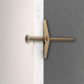 Gold toggle bolt on a gray and white background