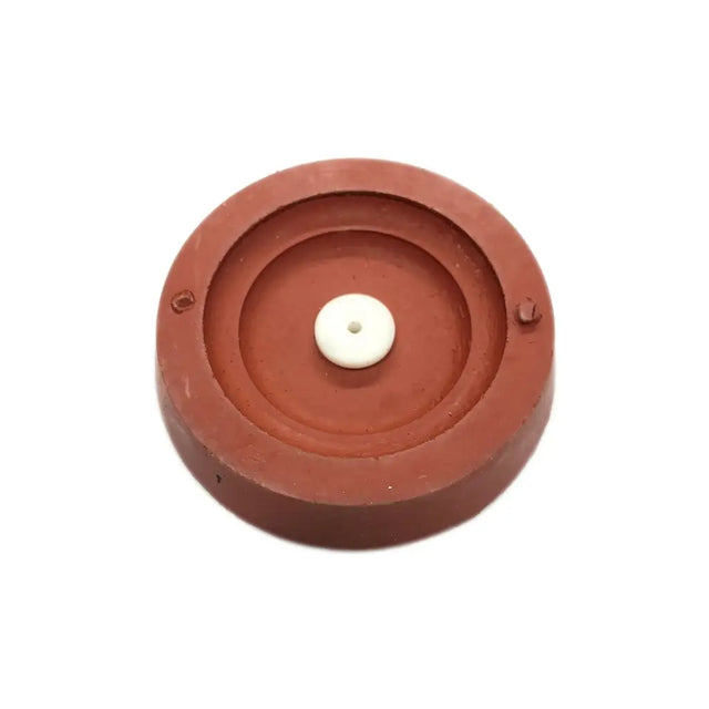 Round red object with a white center on a white background
