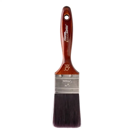Paint brush with wooden handle and black bristles on a white background
