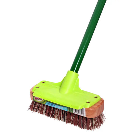 Cleaning brush with green handle and brown bristles on a white background