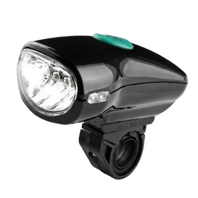 Bicycle headlight with black casing and green switch on a white background