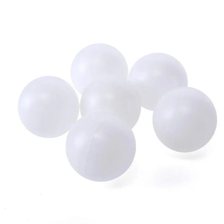 Five white ping pong balls on a white background
