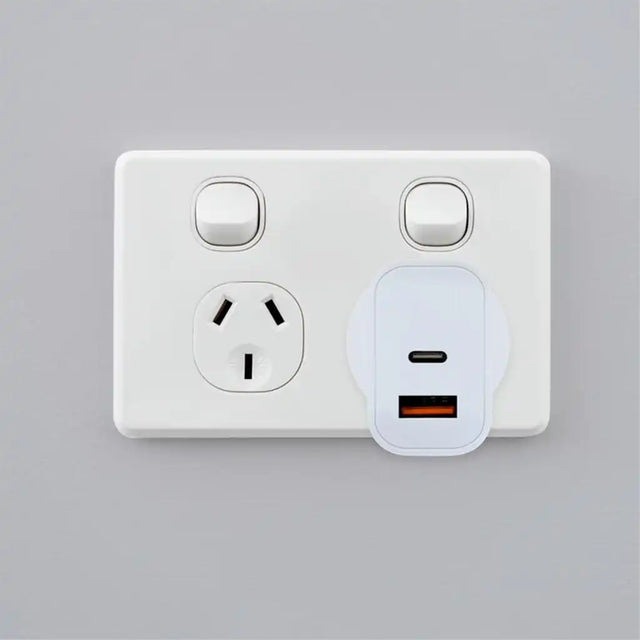 White wall socket with USB-C adapter on a gray background