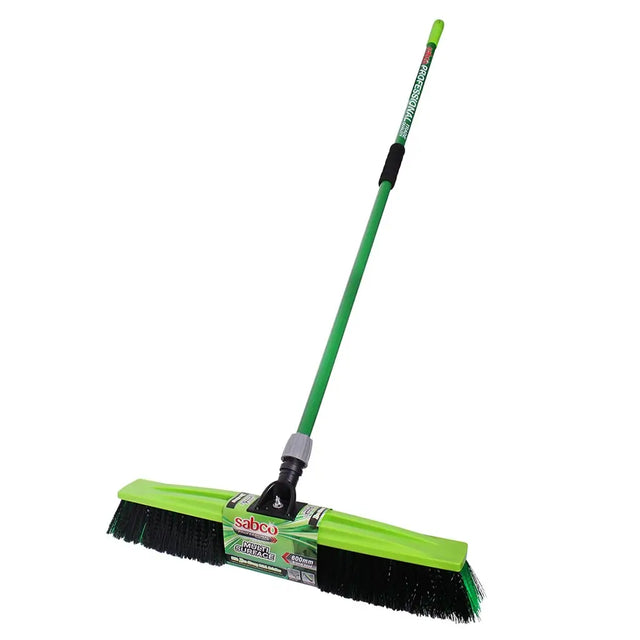 Green broom with black bristles on a white background