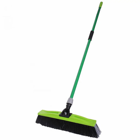 Green and black broom on a white background