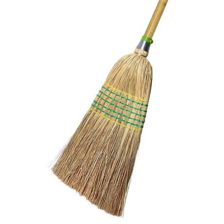 Broom with a wooden handle and straw bristles on a white background
