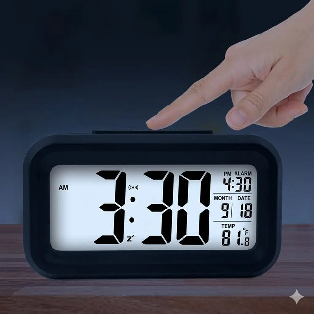 Digital clock with a hand pointing at the time on a dark background