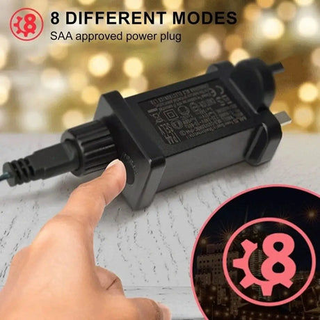 Black power plug with 8 different modes feature, SAA approved, on a blurred background.