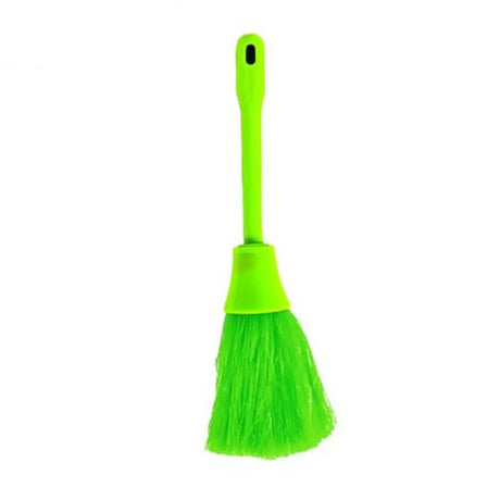 Green broom with a dustpan on a white background
