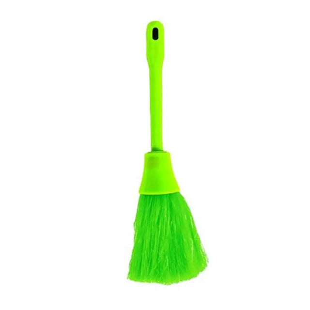 Green broom with a dustpan on a white background
