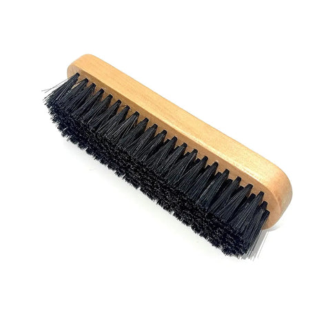 Wooden brush with black bristles on a white background