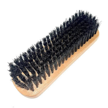 Bristle brush with wooden handle on a white background