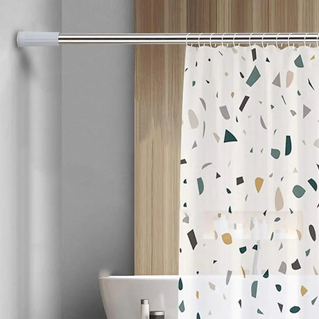 Shower curtain with a terrazzo pattern on a rod in a bathroom setting.