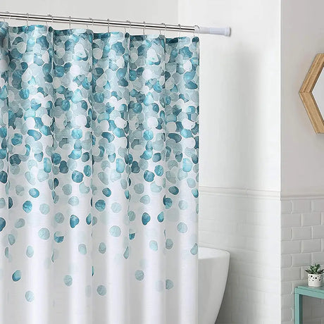 Shower curtain with blue and green abstract pattern in a bathroom setting