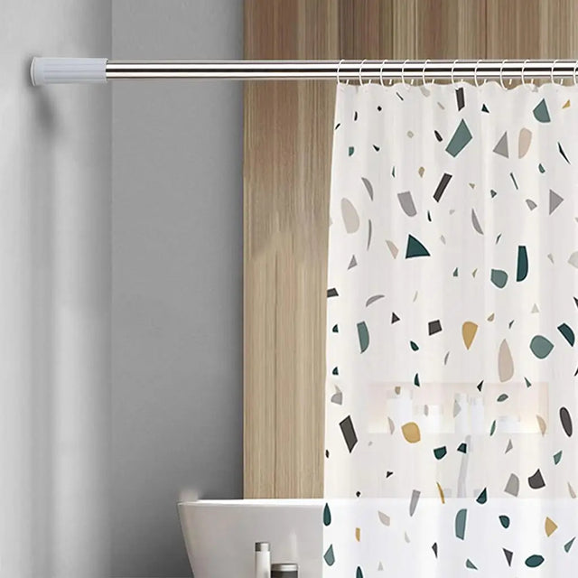 Shower curtain with a terrazzo pattern on a rod in a bathroom setting.