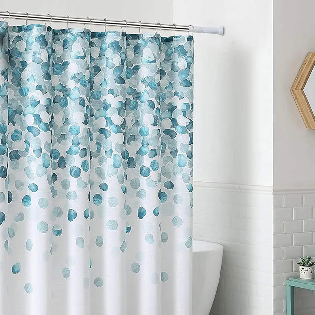 Shower curtain with blue and green abstract pattern in a bathroom setting