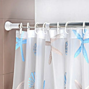 Shower curtain with starfish pattern hanging on a rod against a tiled wall.