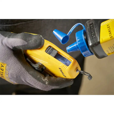 Refilling Stanley chalk reel with blue chalk powder using the sliding door
