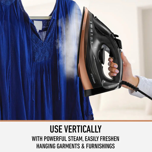 Person ironing a blue garment with text about using steam vertically.