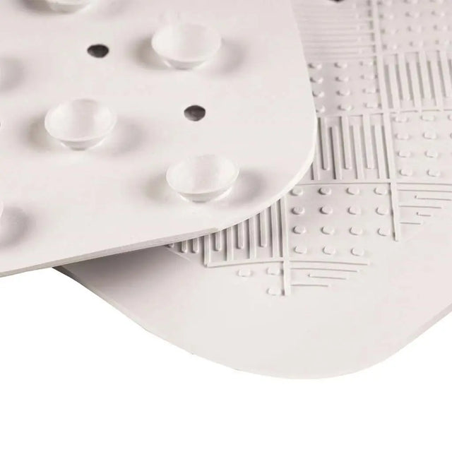 Close-up of a white textured plate with geometric patterns on a white background