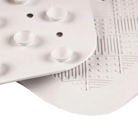 Close-up of a white textured plate with geometric patterns on a white background