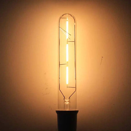 Vintage-style light bulb emitting a warm glow against a plain background